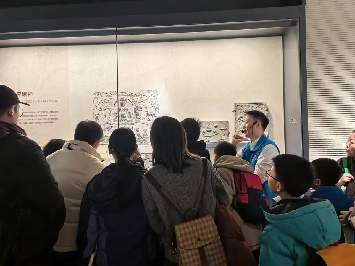 Roots Zhao sharing Chinese culture as a museum volunteer guide