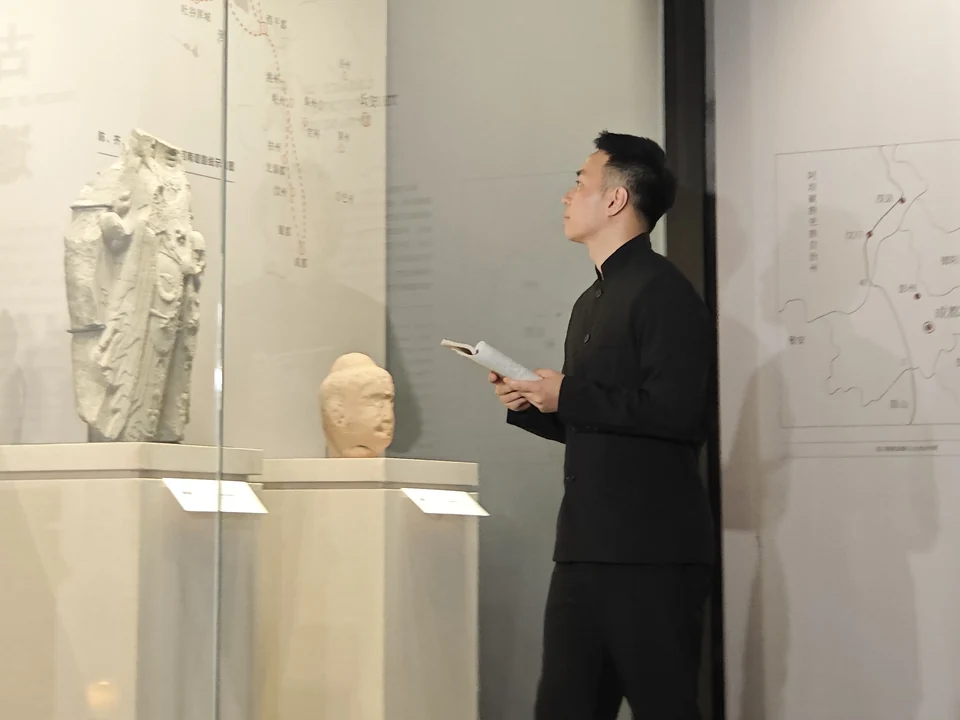 Roots studying historical artifacts while preparing a museum tour