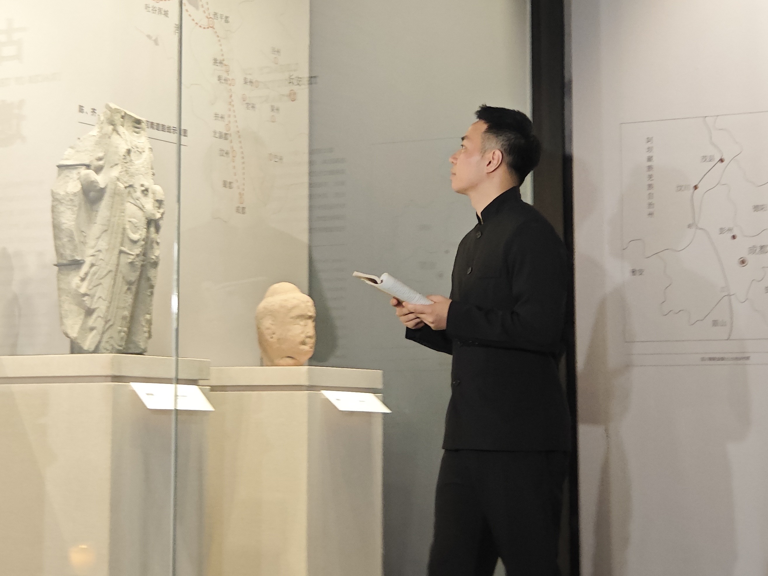 Roots Zhao studying historical artifacts in a museum